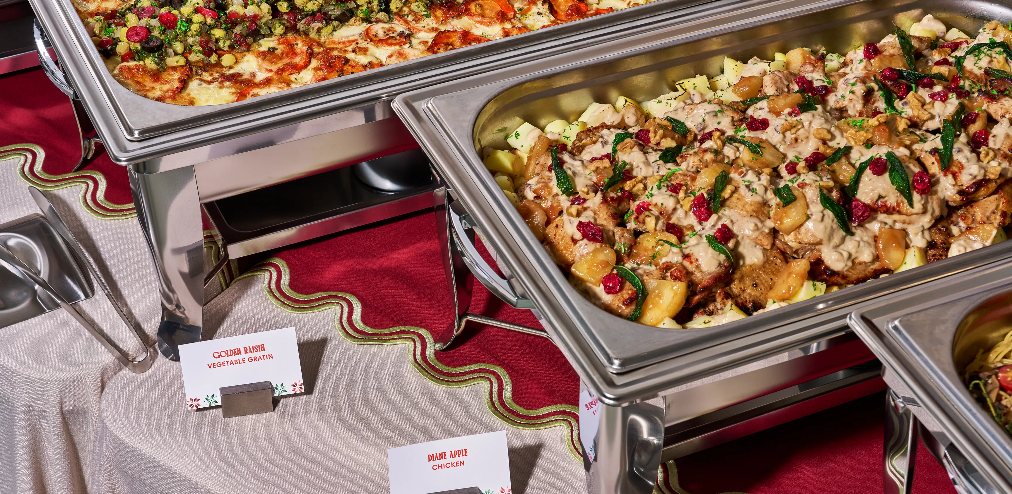 Christmas buffet line in chafing dishes with dish cards